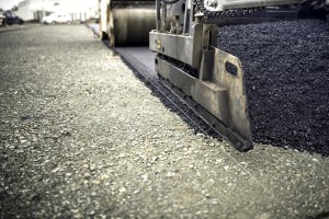 industrial pavement truck laying fresh asphalt, bitumen during r